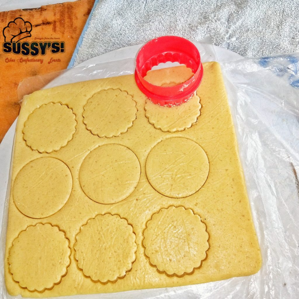 Cutting out shortbread cookies with a cookie cutter